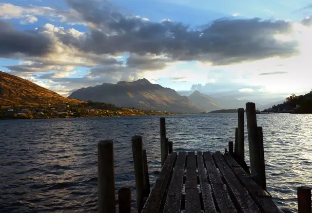 Evening light on the Frankton Arm of Lake Wakatipu, with the far shore in silhouette.