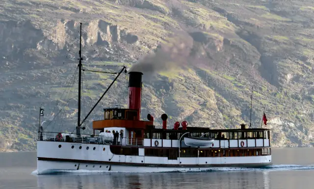 The TSS Earnslaw steamship on Lake Wakatipu, with the Remarkables behind the wake.