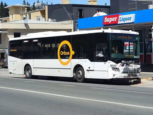 Side view of a yellow Orbus bus in Queenstown, in the later livery.