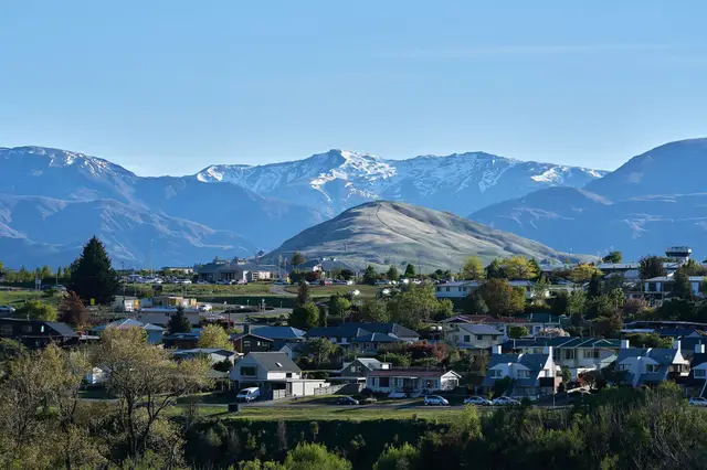 Queenstown and the Frankton Road hillside, with the Remarkables across the lake.