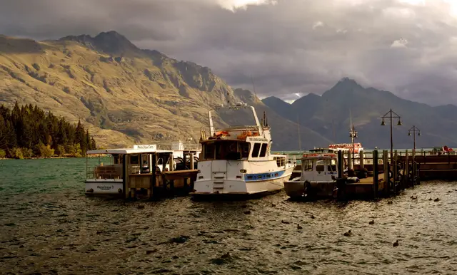 Boats moored in Queenstown Bay in the evening.